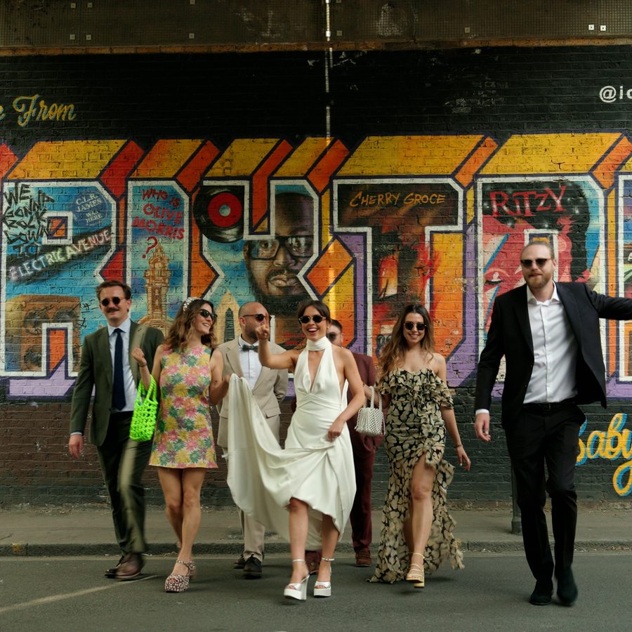 Wedding party at Brixton mural - natural wedding film by Steer Media